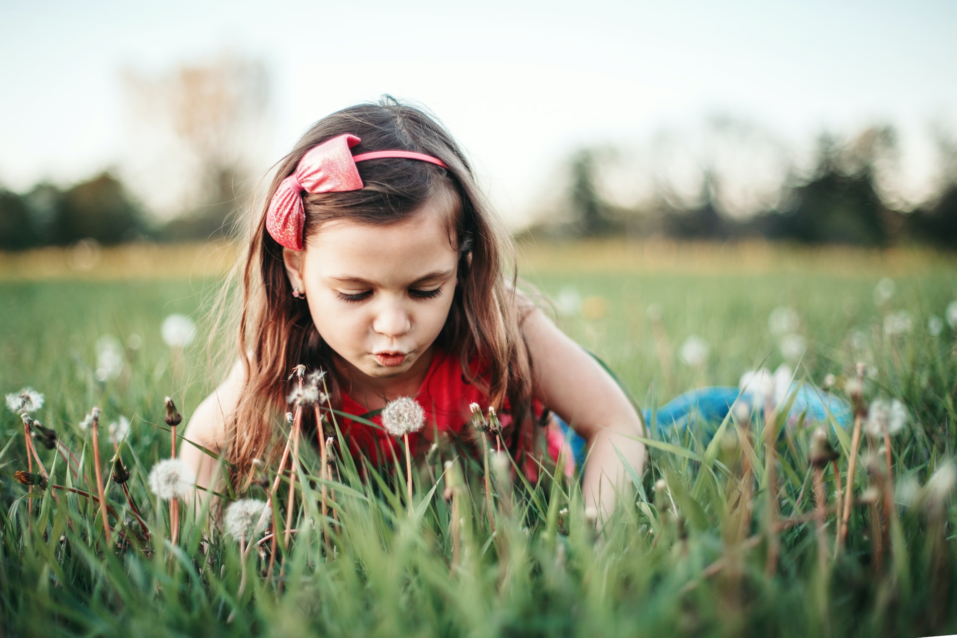 little girl playing in a field